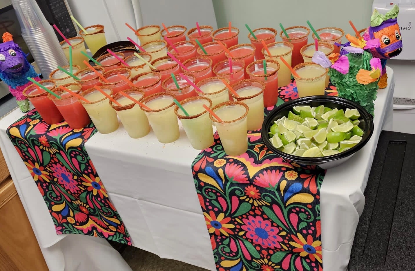 Mia's catering drinks display with piñatas