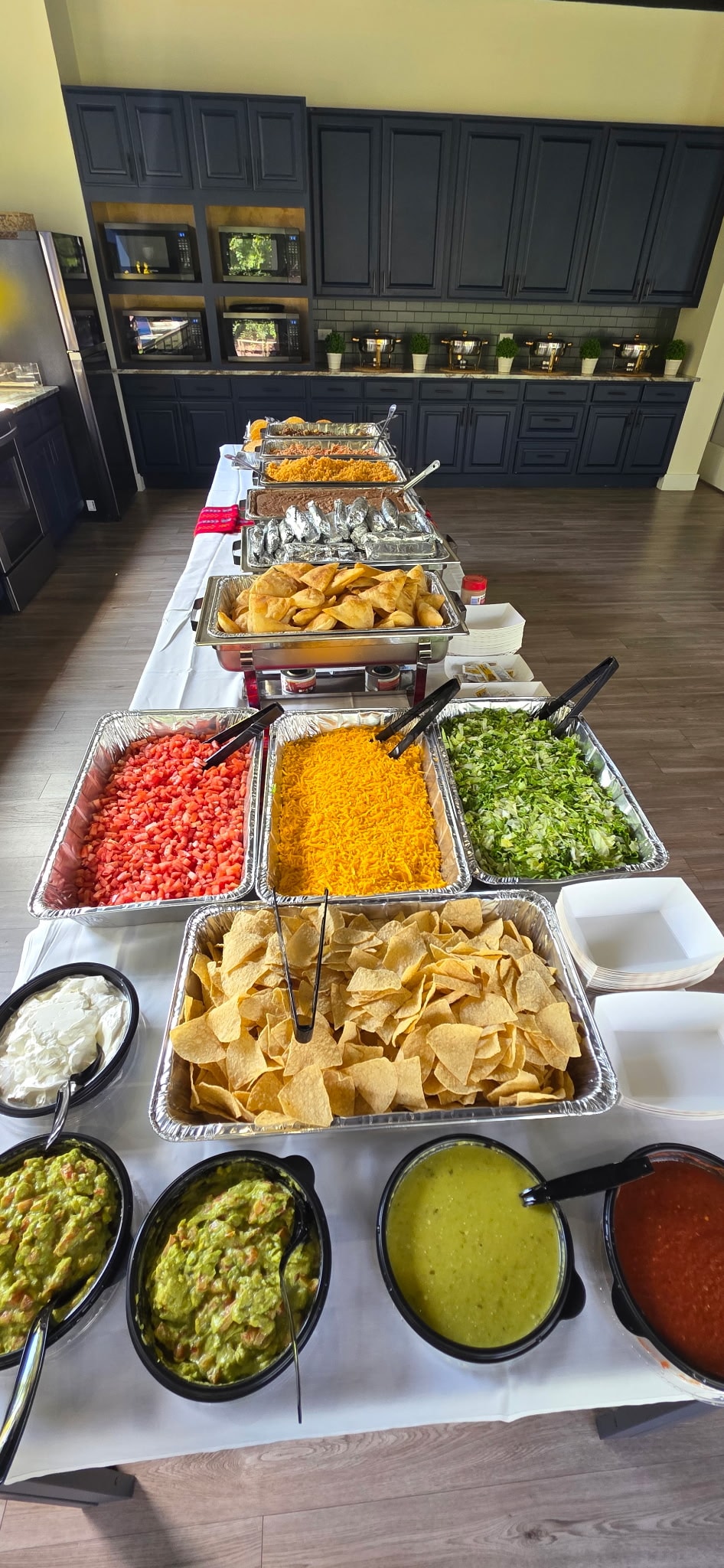 Mia's catering buffet spread with sides and sauces