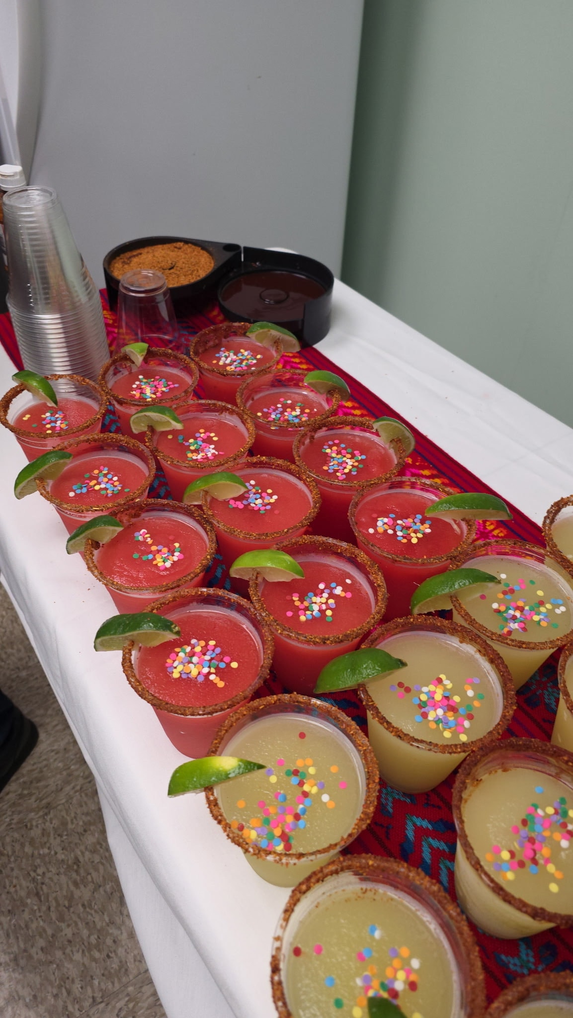 Mia's catering margarita cups with confetti and lime